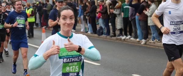 Lady running the Bath Half for Genesis Trust