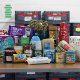 A photo of donated food sitting on a table.