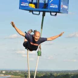 Man leaping from a platform looking terrified.