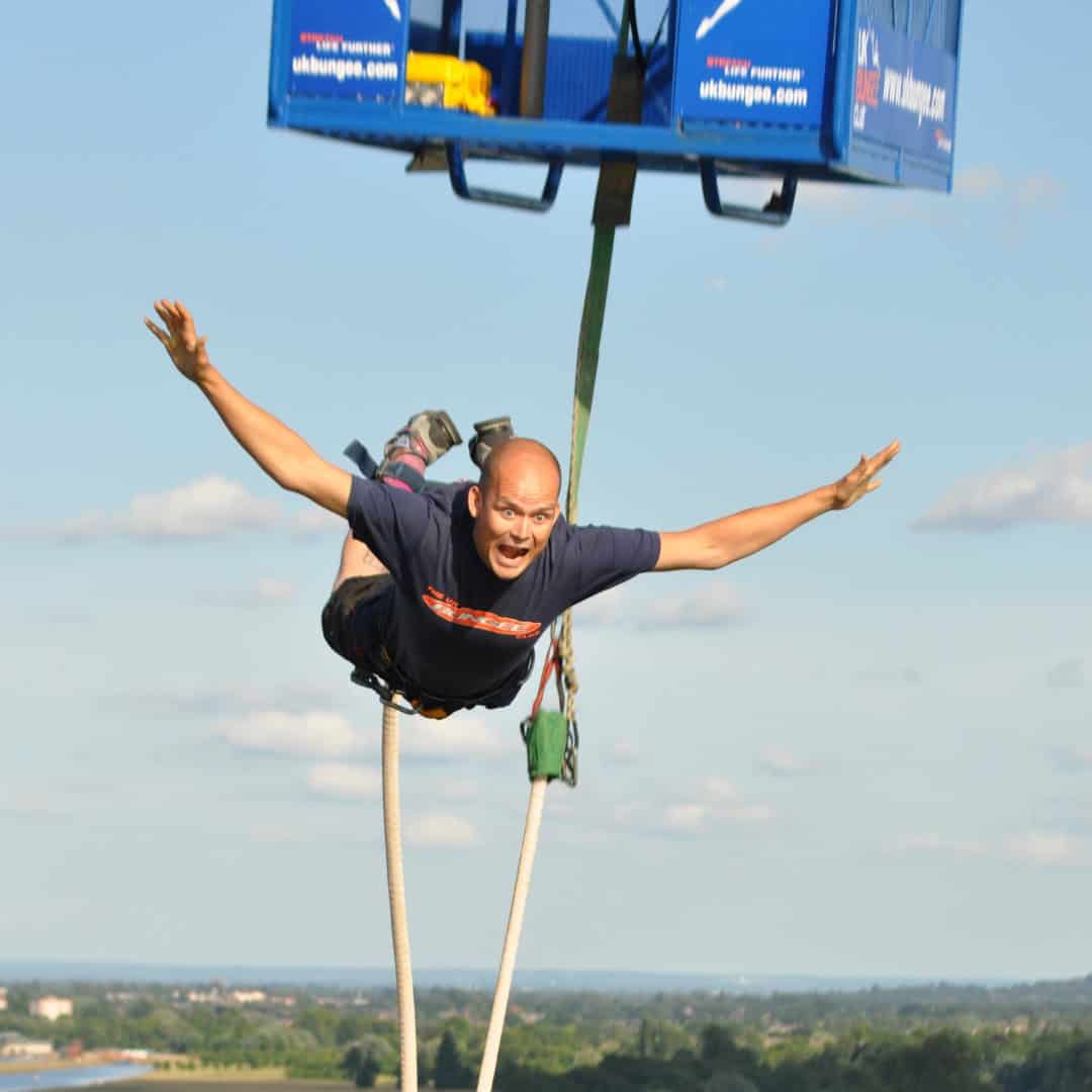 Man leaping from a platform looking terrified.