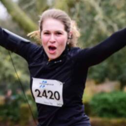 Woman celebrating finishing a race in Chepstow, Wales