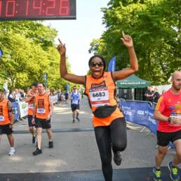 woman celbrating as she crosses the finish line