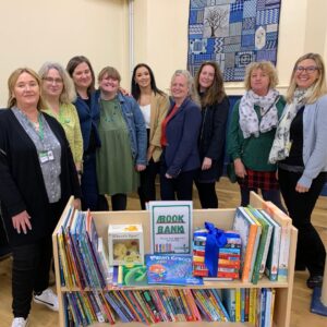 people standing around the book bank at the grand opening