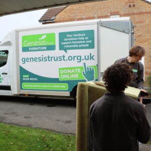 Furniture collection team carrying sofa out to our van.