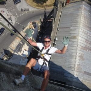 Man abseiling down Bath Abbey