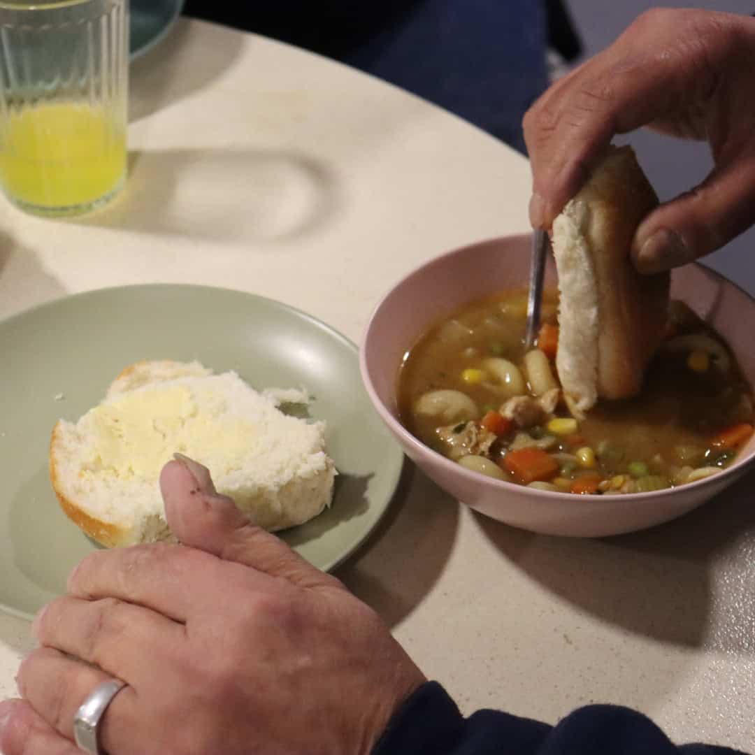 Photo of person eating some homemade soup.