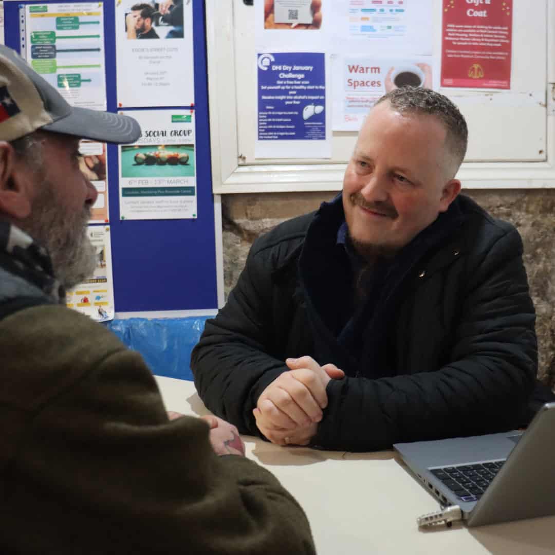 Genesis team member meeting with a man