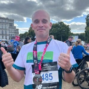One of Genesis Trust's runners holding a medal.