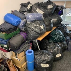 full bin bags of donated winter clothes